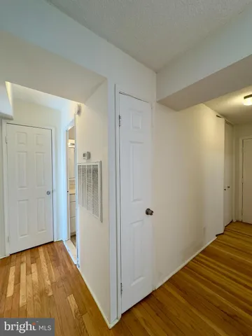 a view of a room with wooden floor and staircase