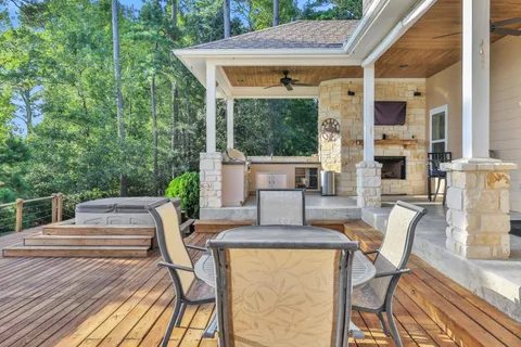 a view of patio with table and chairs and wooden floor