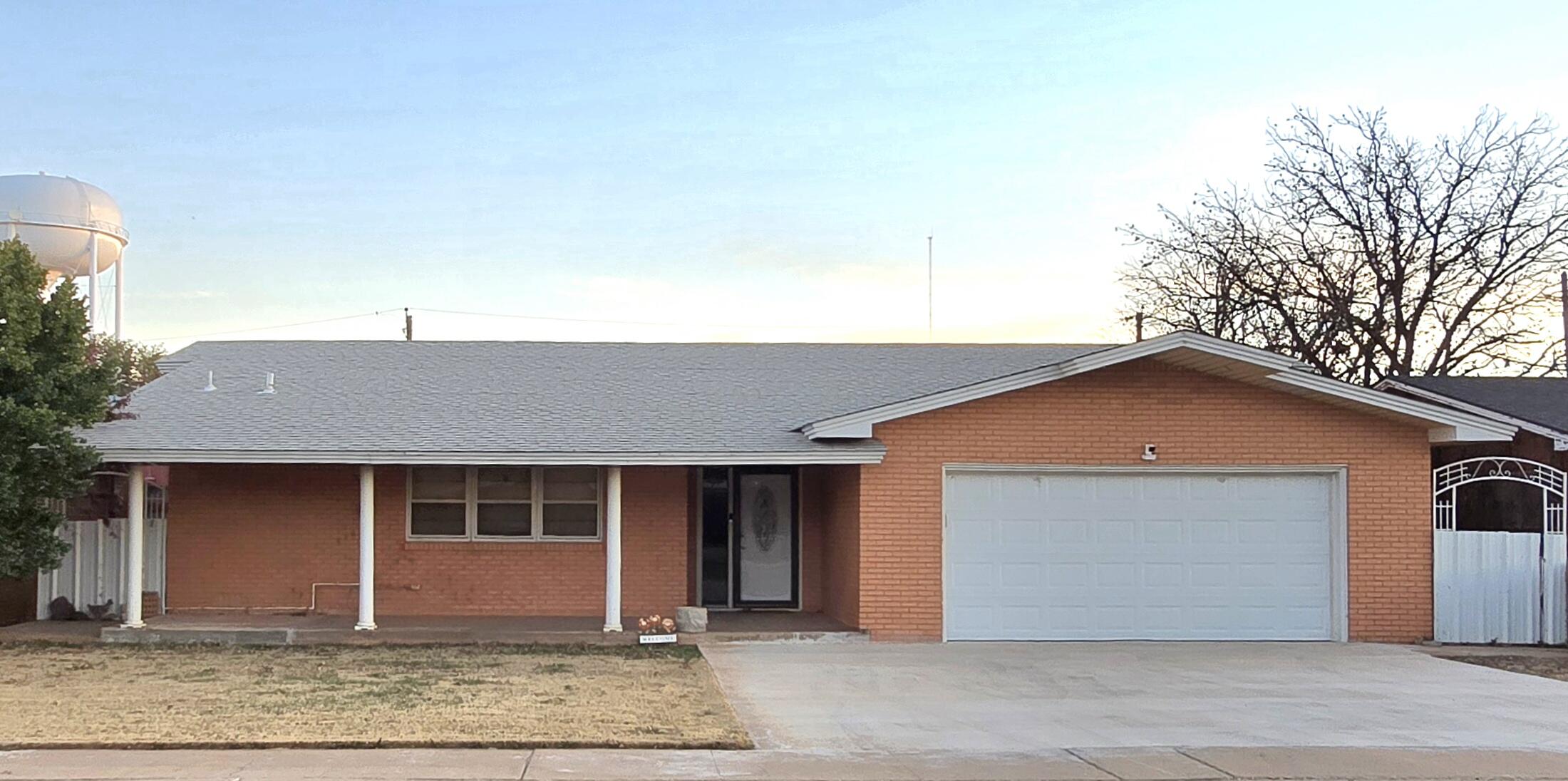 2229 South 6th Street Lamesa, TX 79331 - Photo 1 of 27 a front view of a house with garden