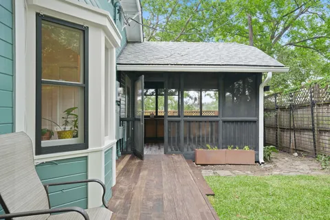 a view of a chair and table in backyard of the house