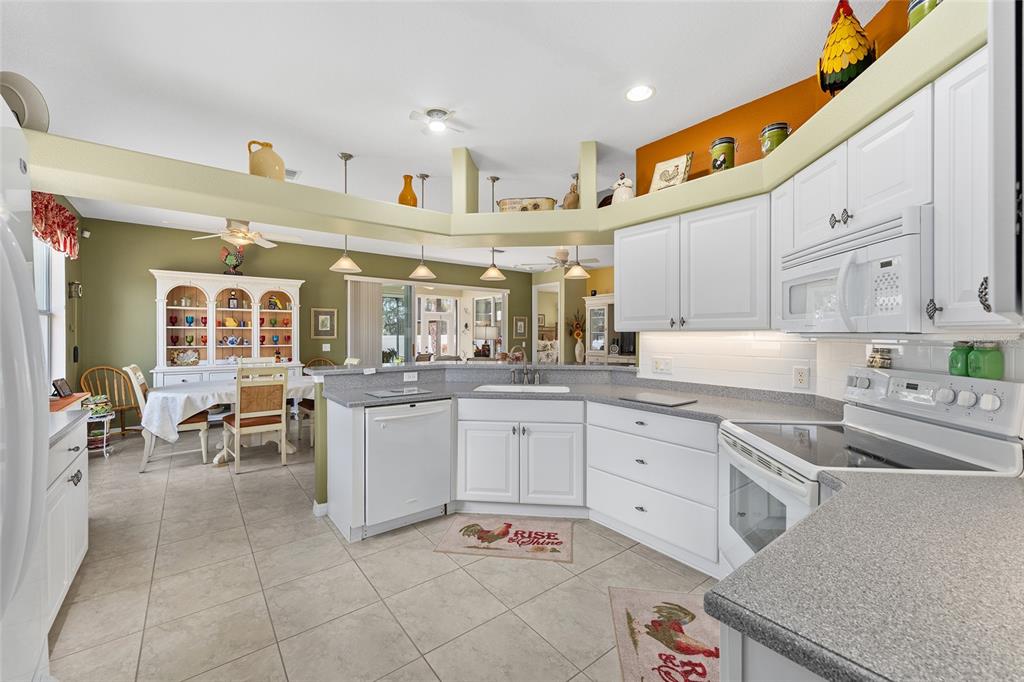 16339 Southwest 14th Avenue Road Ocala, FL 34473 - Photo 10 of 22 a large white kitchen with cabinets