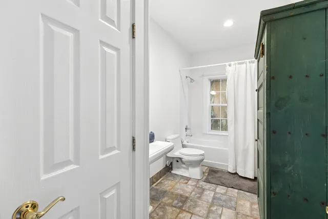 a bathroom with a toilet a sink and a shower