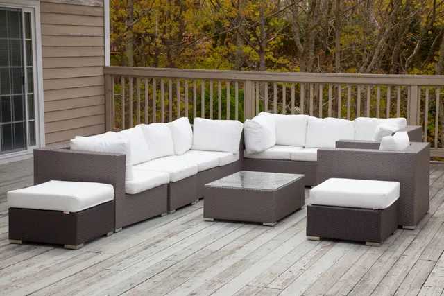 a roof deck with couches and wooden floor
