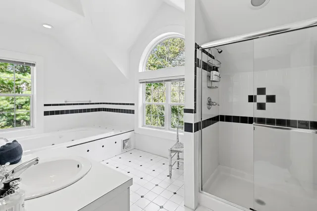 a bathroom with a bathtub and a shower sink