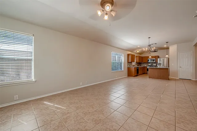 a view of a livingroom with furniture and chandelier fan