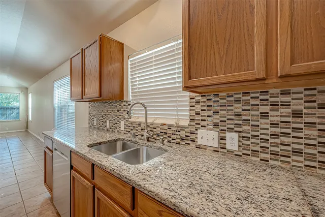 a kitchen with a sink cabinets and utility