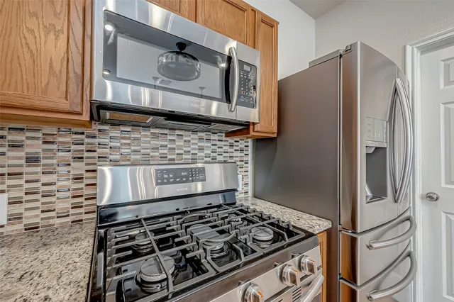 a kitchen with stove and refrigerator