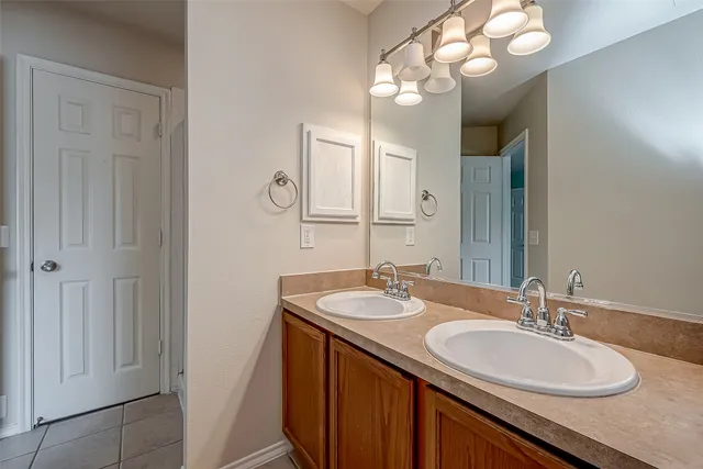 a bathroom with a sink double vanity and a mirror