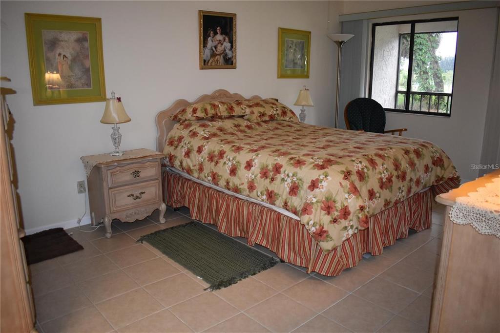 1716 Golf View Drive, Unit 1716 Tarpon Springs, FL 34689 - Photo 12 of 32 a bedroom with a bed and a window