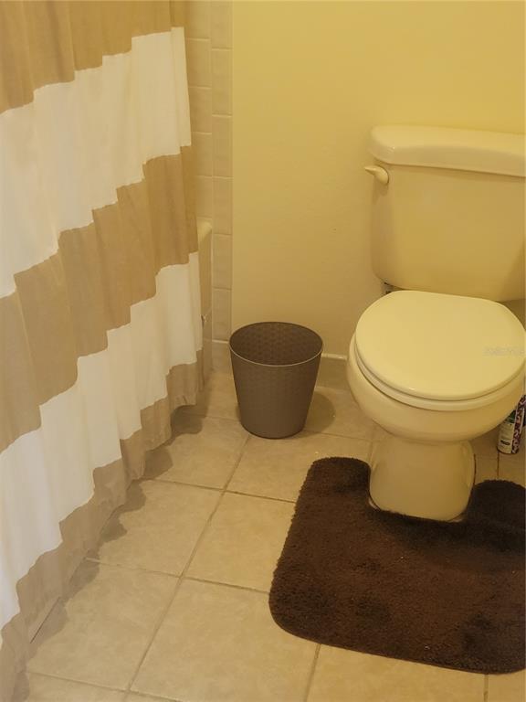 1716 Golf View Drive, Unit 1716 Tarpon Springs, FL 34689 - Photo 14 of 32 a bathroom with a toilet and a shower