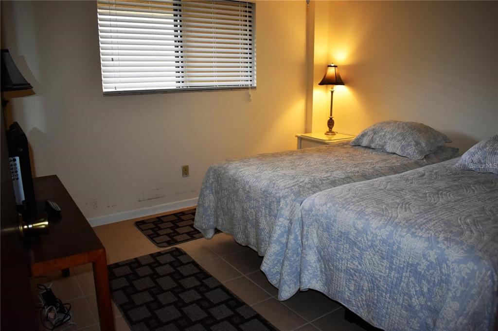 1716 Golf View Drive, Unit 1716 Tarpon Springs, FL 34689 - Photo 16 of 32 a bedroom with a bed and a window
