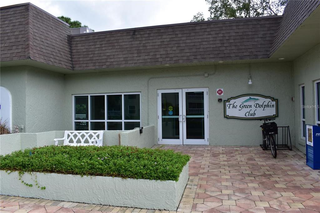1716 Golf View Drive, Unit 1716 Tarpon Springs, FL 34689 - Photo 23 of 32 a front view of a building with garden