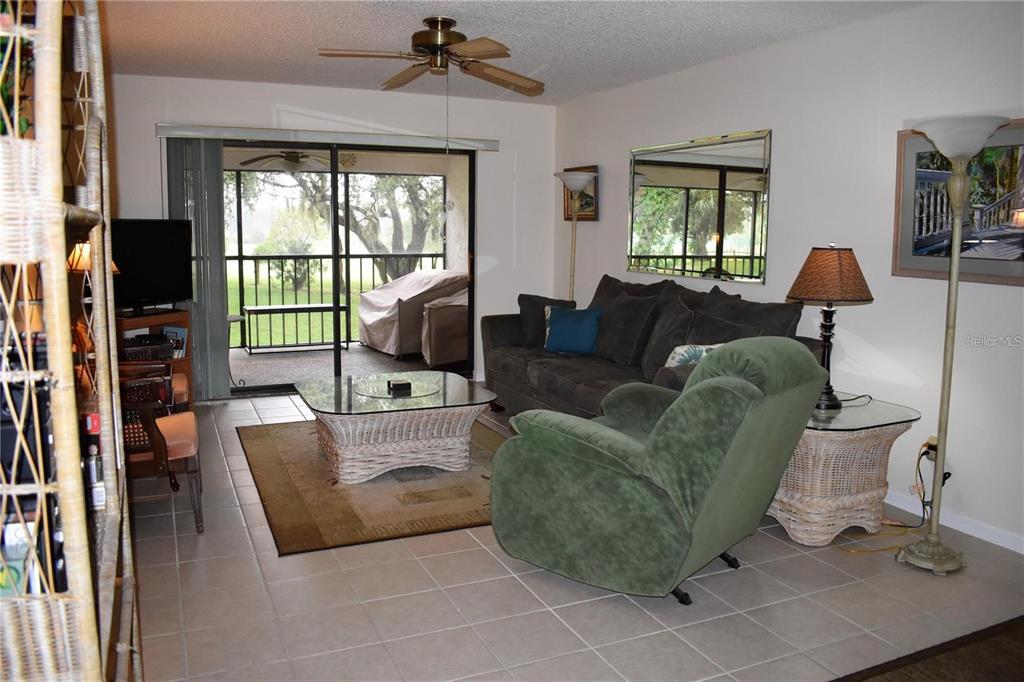 1716 Golf View Drive, Unit 1716 Tarpon Springs, FL 34689 - Photo 7 of 32 a living room with furniture and a window