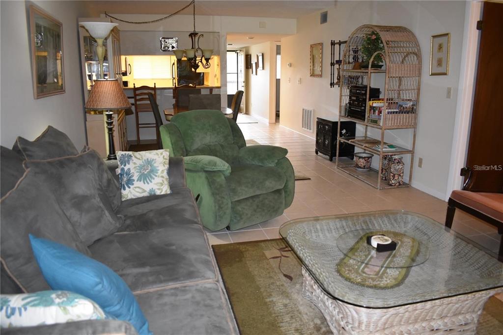 1716 Golf View Drive, Unit 1716 Tarpon Springs, FL 34689 - Photo 8 of 32 a living room with furniture and a table