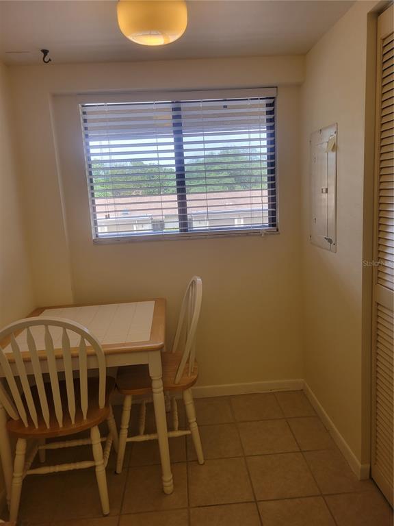 1716 Golf View Drive, Unit 1716 Tarpon Springs, FL 34689 - Photo 10 of 32 a view of a dining room with furniture and window