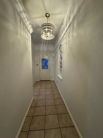 a view of an empty room and a window