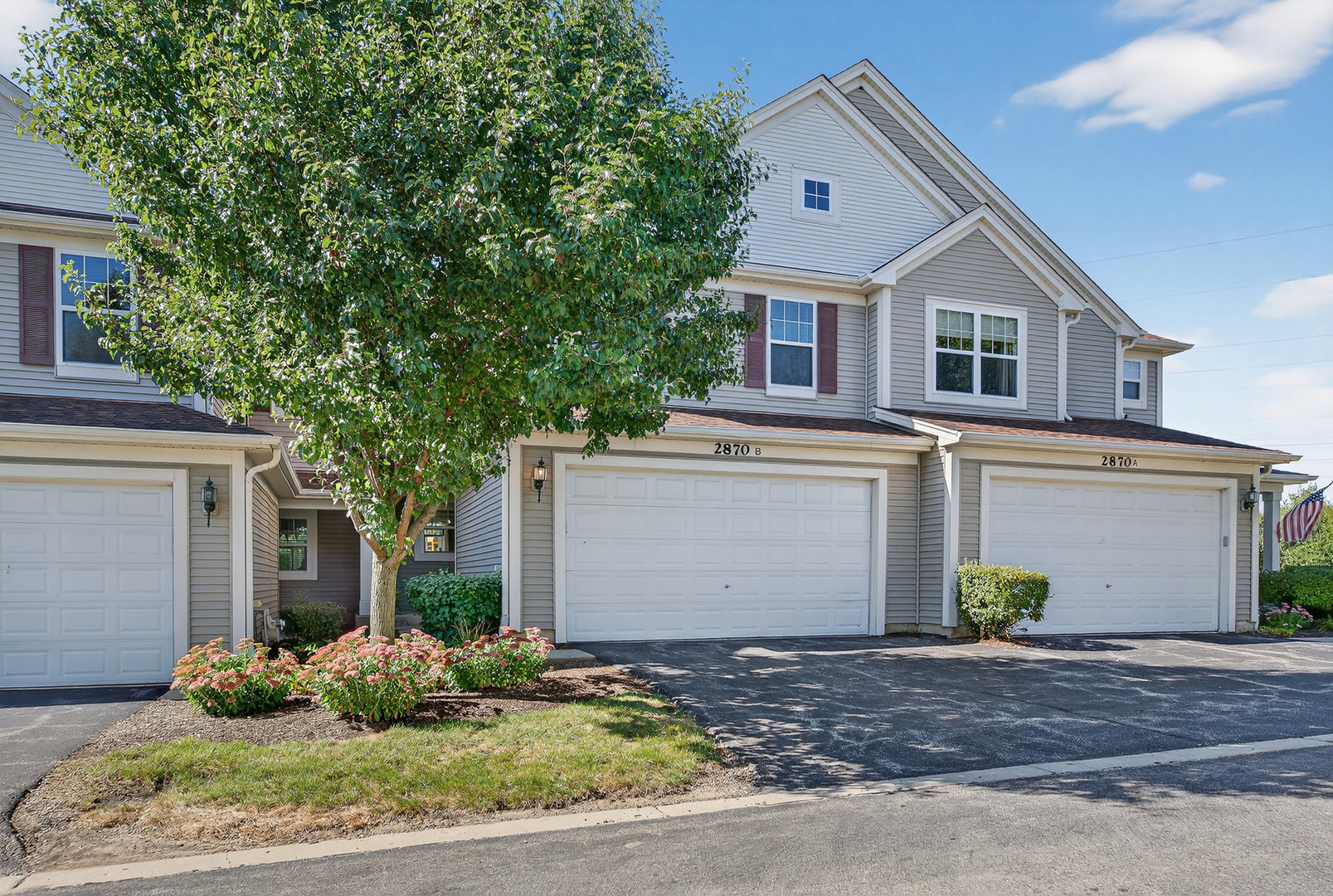 2870 Glacier Way, Unit B Wauconda, IL 60084 - Photo 2 of 35 a front view of a house with a yard and garage