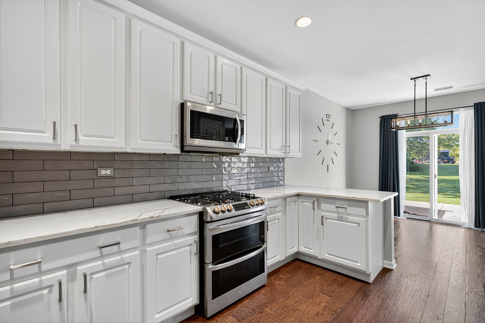 2870 Glacier Way, Unit B Wauconda, IL 60084 - Photo 7 of 35 a kitchen with stainless steel appliances white cabinets and a stove top oven
