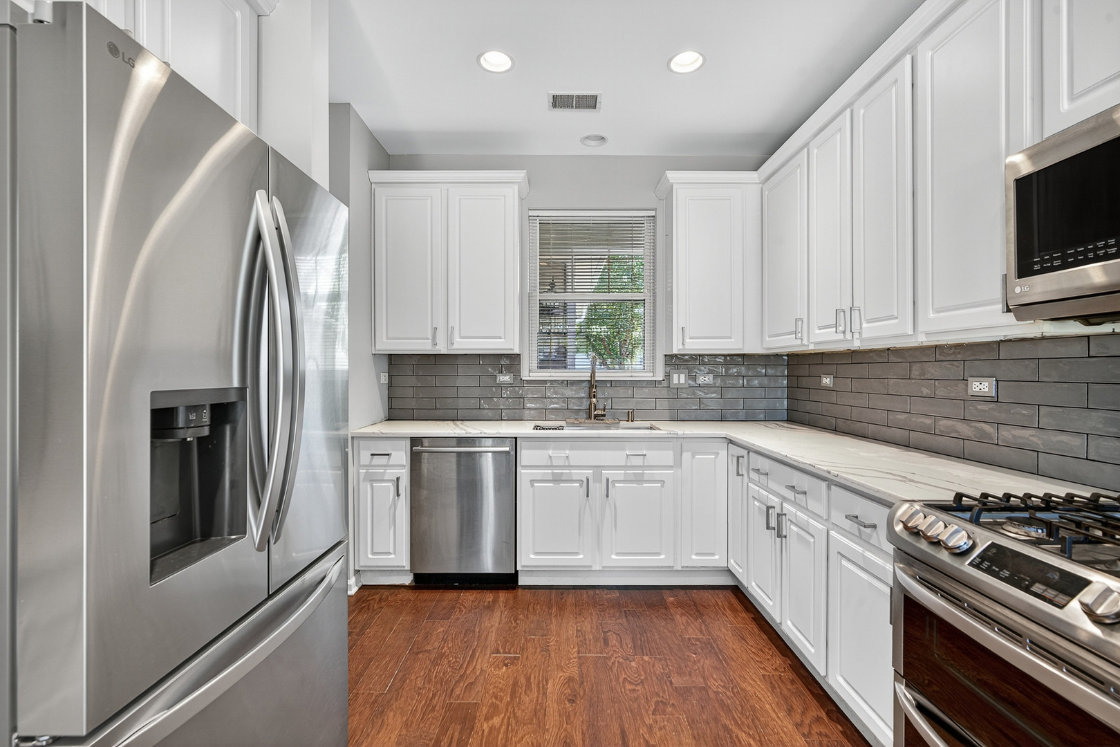 2870 Glacier Way, Unit B Wauconda, IL 60084 - Photo 9 of 35 a kitchen with stainless steel appliances granite countertop a stove a sink and a refrigerator