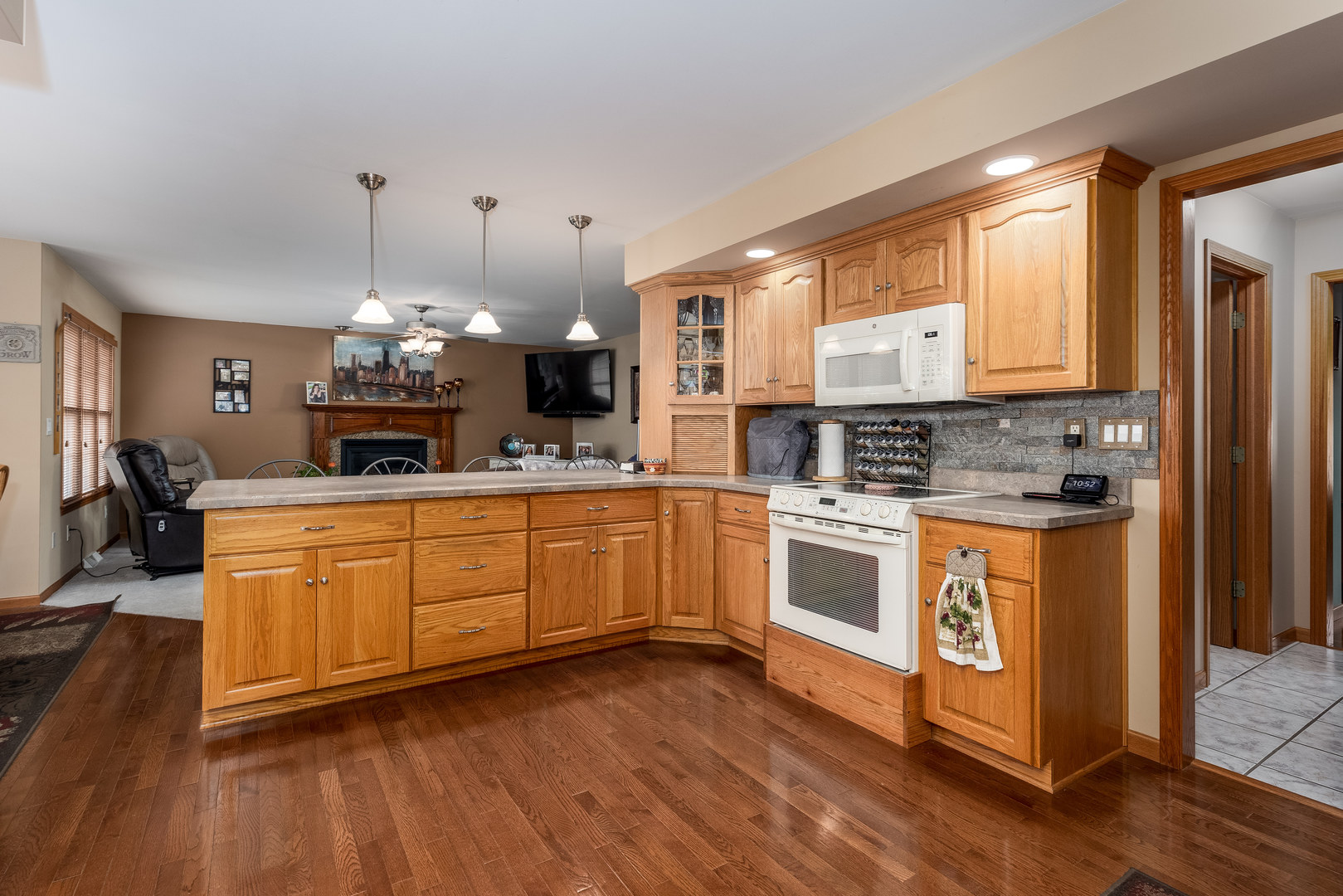 3622 East 1769th Road Ottawa, IL 61350 - Photo 11 of 42 a kitchen with stainless steel appliances granite countertop a stove a sink dishwasher and a refrigerator with wooden floor