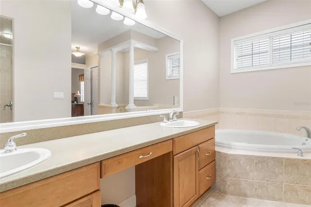 a bathroom with a granite countertop sink a toilet and shower