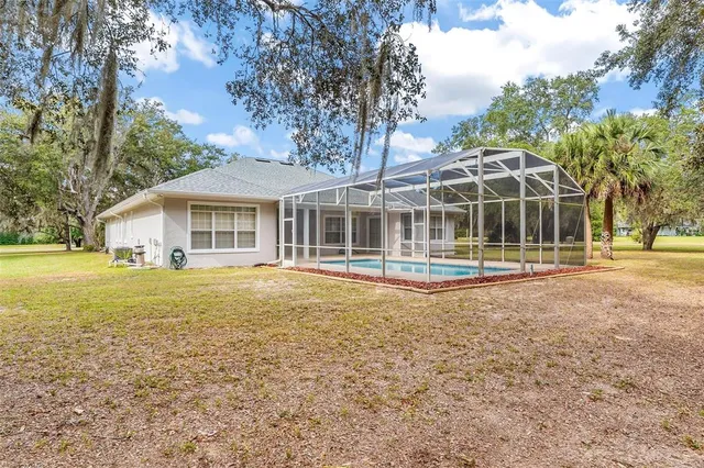 an aerial view of a house with swimming pool and garden