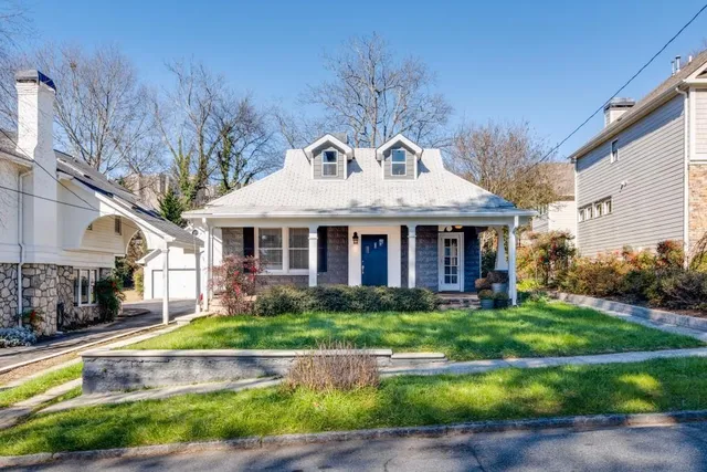 a front view of a house with a yard table and chairs