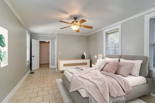 a bedroom with a bed and a chandelier