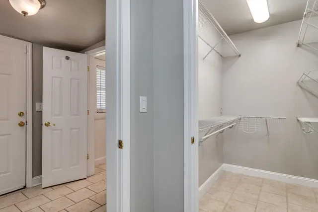 an empty room with a window and wooden floor