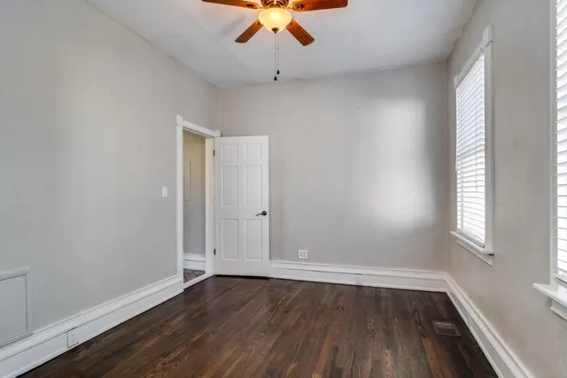 a room with a bed mirror and window