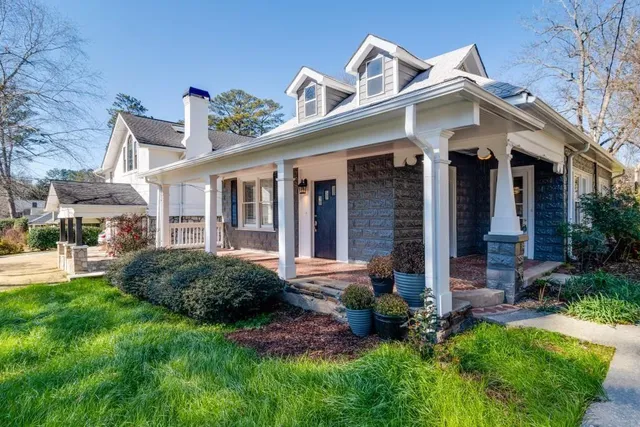 a front view of a house with a yard and porch