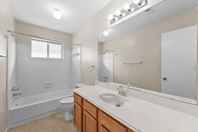 a bathroom with a tub a sink and mirror