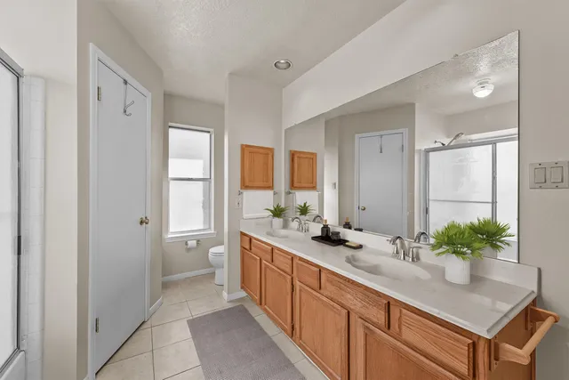 a spacious bathroom with a sink and a mirror