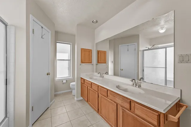 a spacious bathroom with a double vanity sink mirror and double