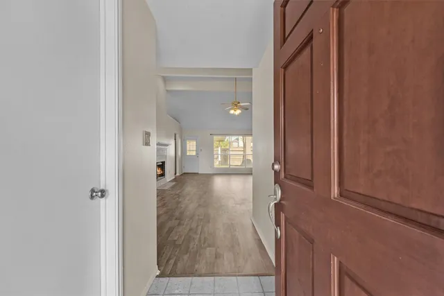 a view of hallway with wooden floor