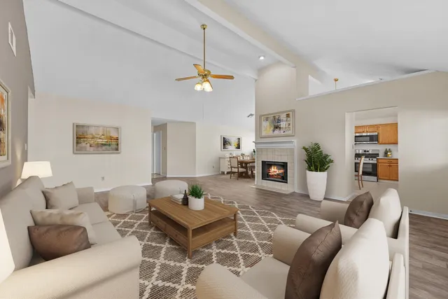 a living room with furniture a dining table and a fireplace