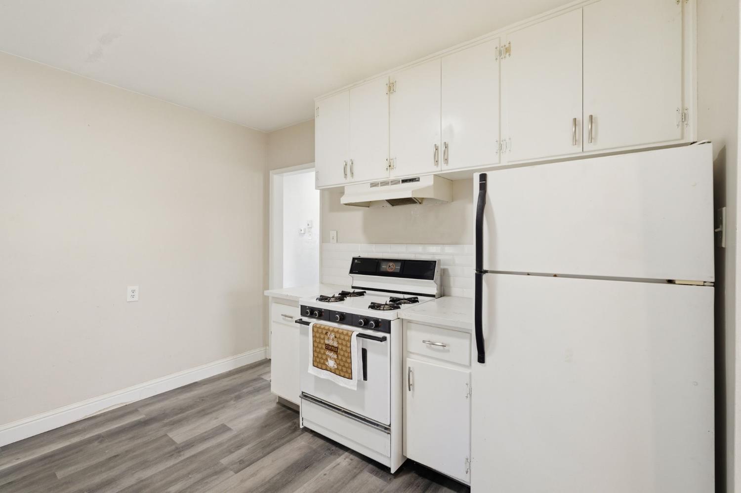 133 Oleander Avenue Lemoore, CA 93245 - Photo 15 of 30 a white refrigerator freezer and a stove sitting inside of a kitchen
