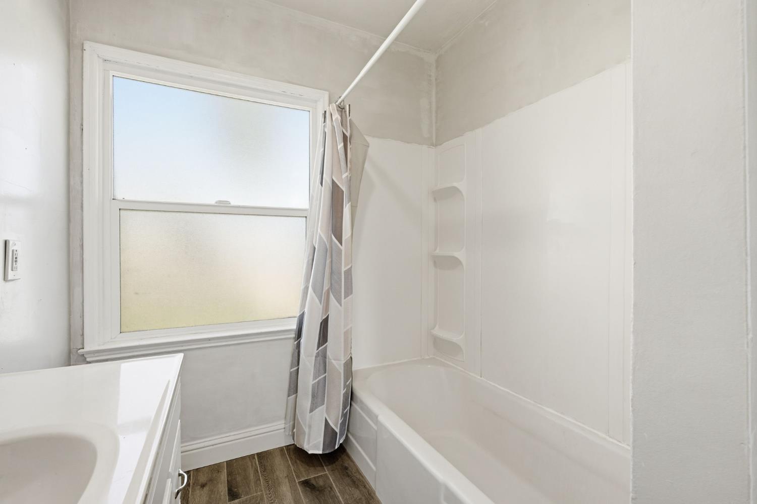 133 Oleander Avenue Lemoore, CA 93245 - Photo 18 of 30 a bathroom with a bathtub and a shower