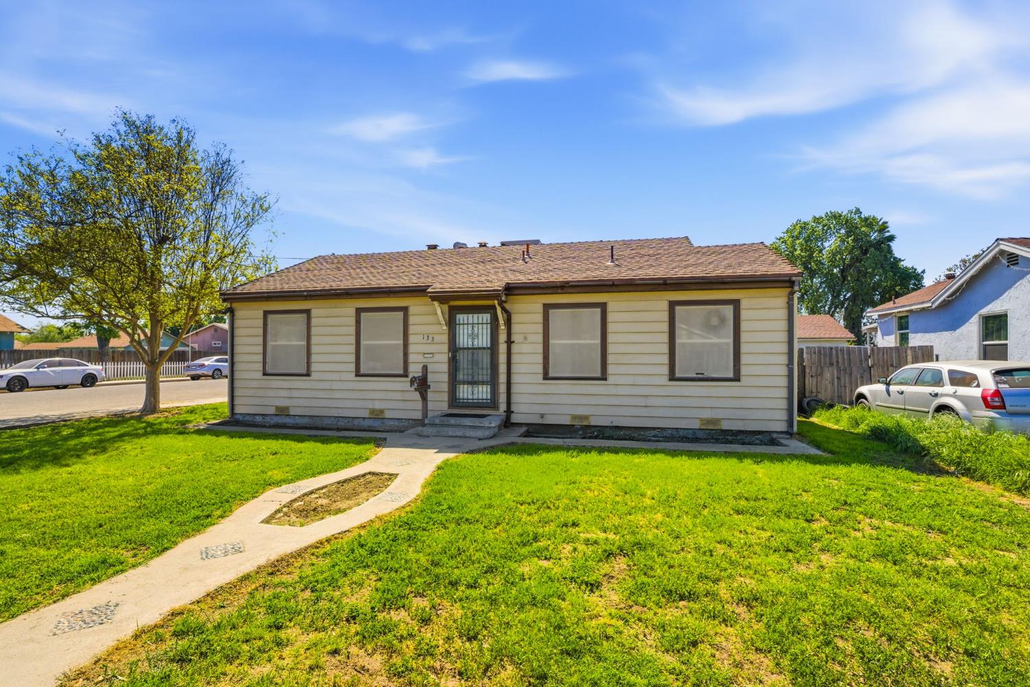 133 Oleander Avenue Lemoore, CA 93245 - Photo 2 of 30 a view of a house with a swimming pool and a yard