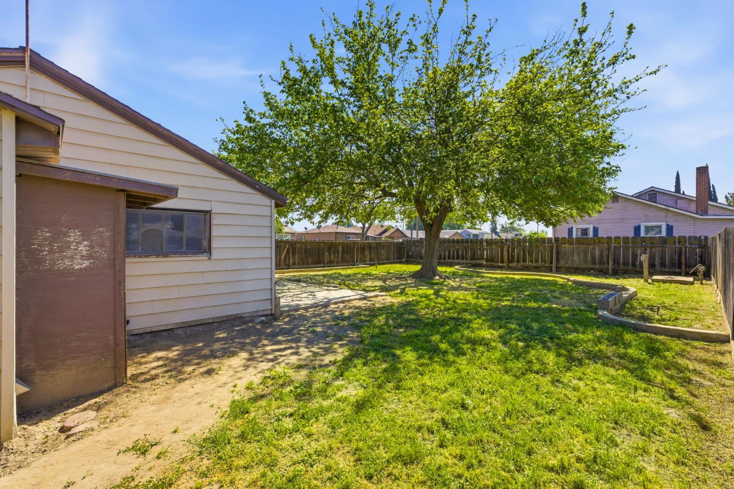 133 Oleander Avenue Lemoore, CA 93245 - Photo 27 of 30 a view of a backyard with a small cabin