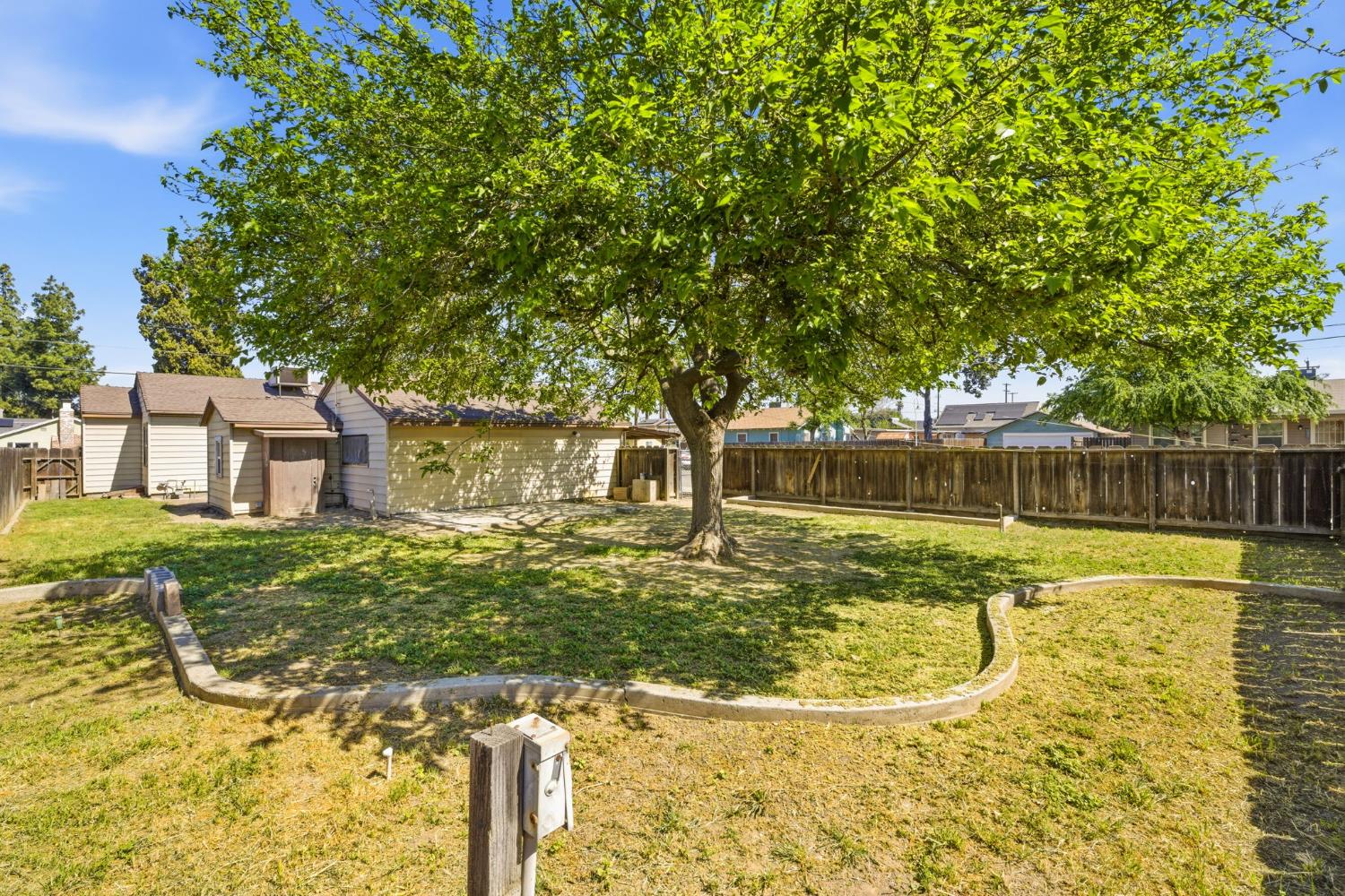 133 Oleander Avenue Lemoore, CA 93245 - Photo 28 of 30 a view of a house with pool yard and a large tree
