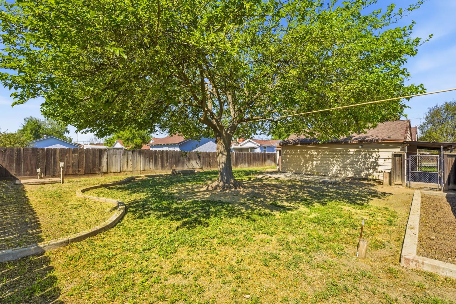 133 Oleander Avenue Lemoore, CA 93245 - Photo 29 of 30 a view of a yard with swimming pool
