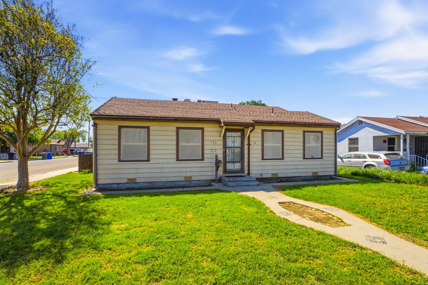 133 Oleander Avenue Lemoore, CA 93245 - Photo 3 of 30 a front view of a house with a yard