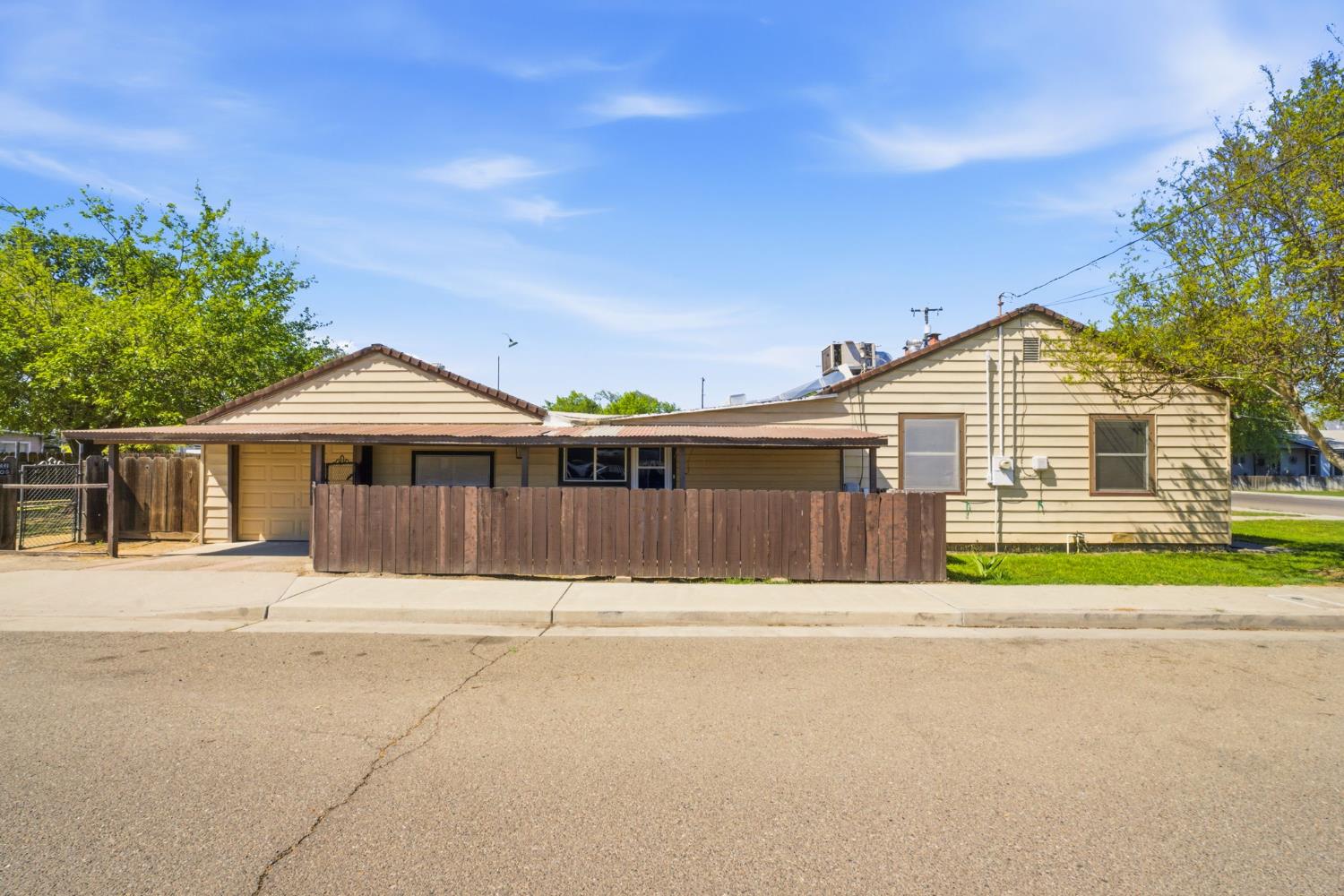 133 Oleander Avenue Lemoore, CA 93245 - Photo 5 of 30 a front view of a house with a yard and garage