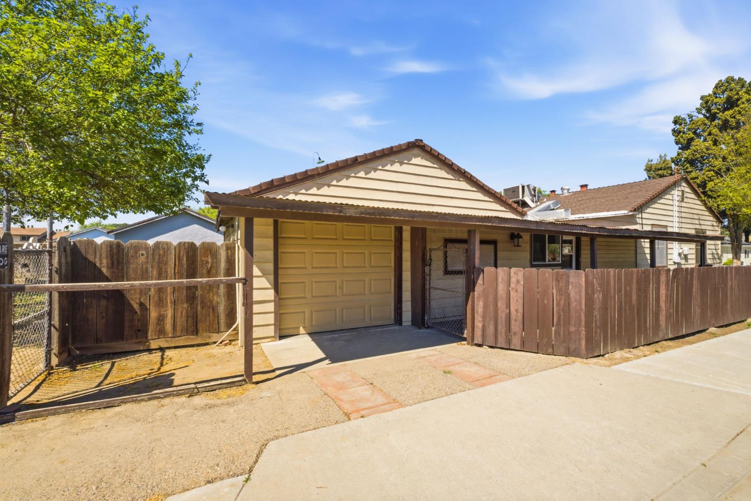 133 Oleander Avenue Lemoore, CA 93245 - Photo 7 of 30 a front view of a house with a garage