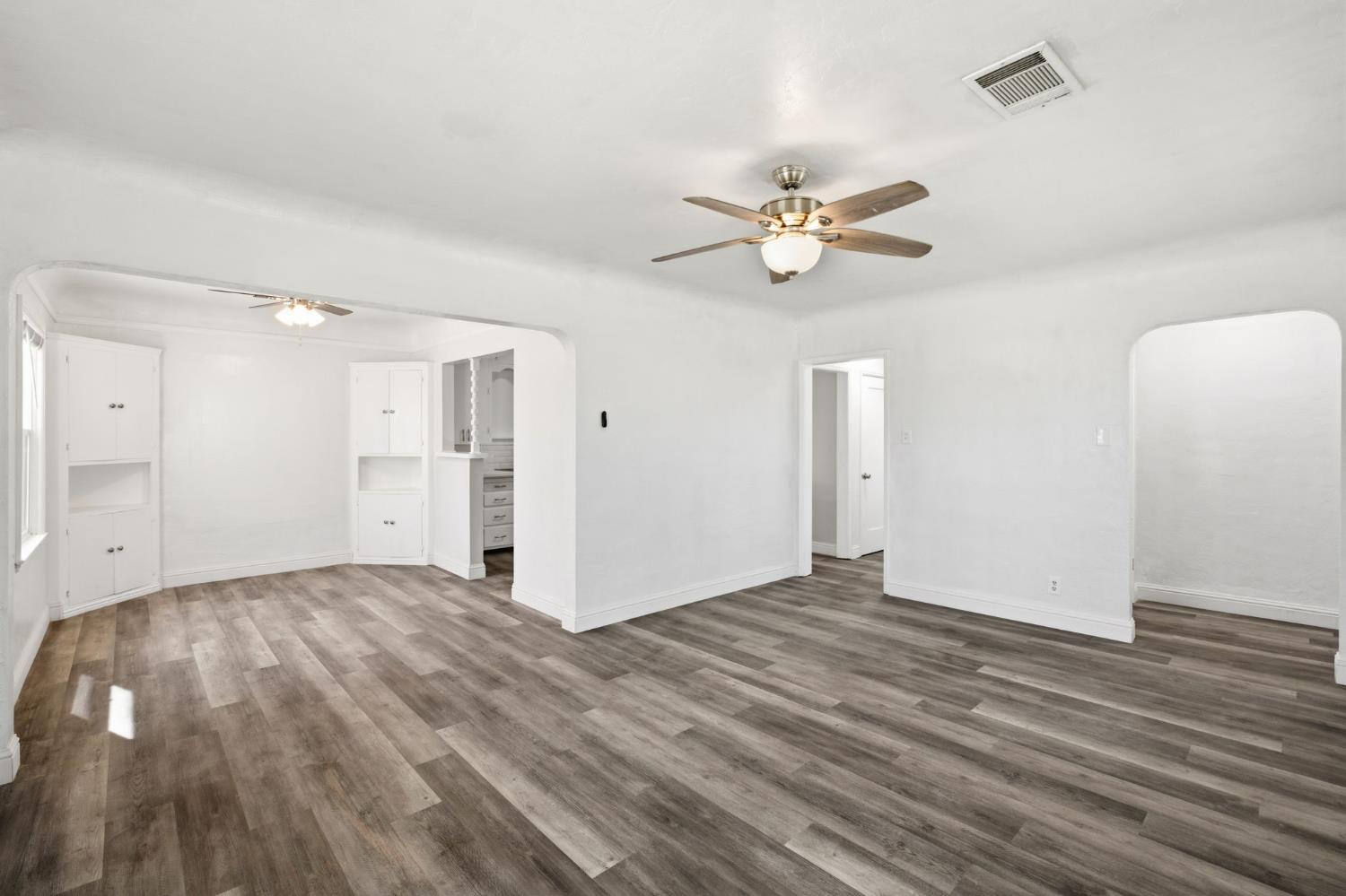133 Oleander Avenue Lemoore, CA 93245 - Photo 8 of 30 a view of empty room with wooden floor