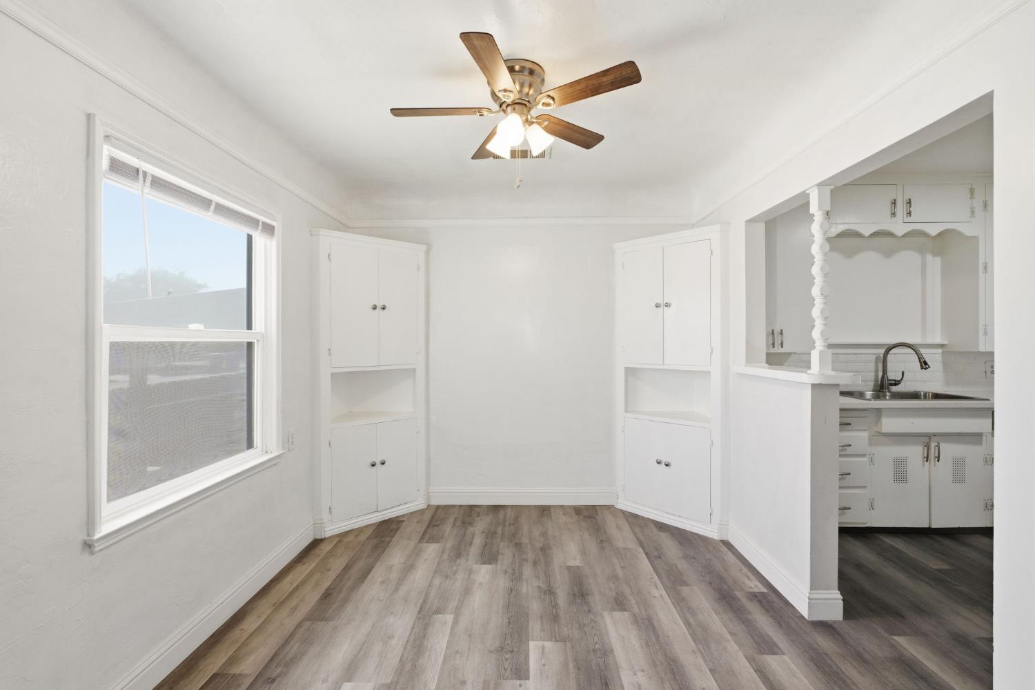 133 Oleander Avenue Lemoore, CA 93245 - Photo 10 of 30 a view of an empty room with window and cabinet