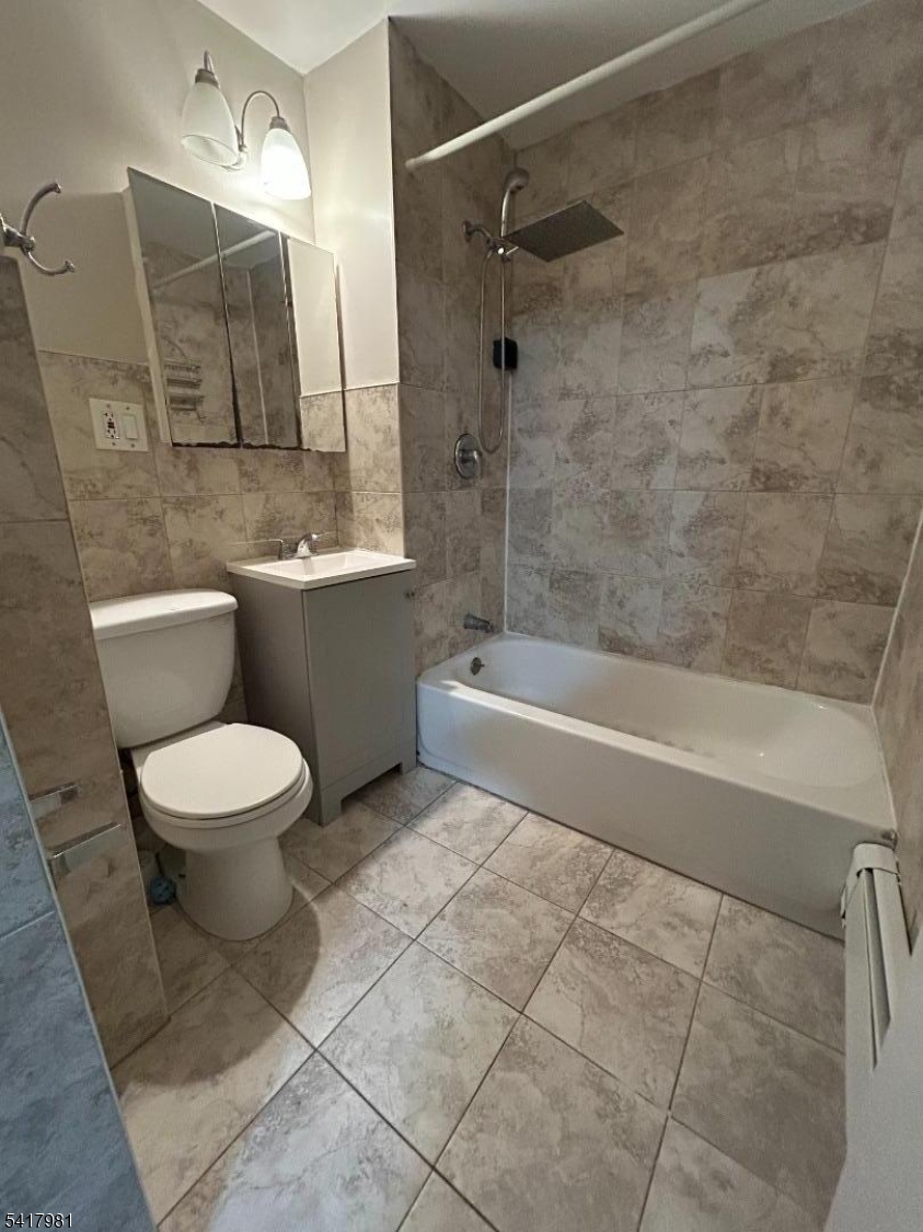 184 Walnut Street Newark, NJ 07105 - Photo 7 of 11 a bathroom with a toilet sink and bathtub