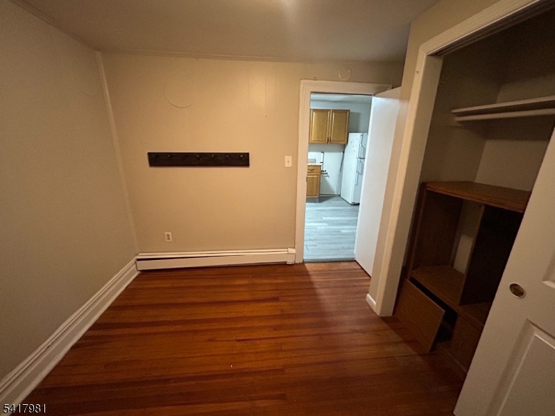 184 Walnut Street Newark, NJ 07105 - Photo 10 of 11 a view of an empty room with wooden floor