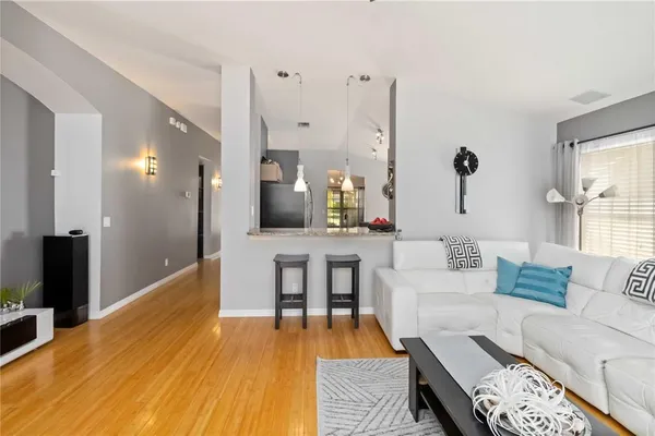 a living room with furniture and wooden floor